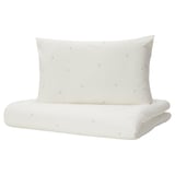Conxunto de roupa de cama para bebés branco con deseño de lúa crecente, feito de algodón suave, de forma rectangular.