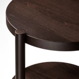 Mesa de café redonda de madeira escura con patas metálicas. A mesa mostra grans de madeira natural. As pernas son cilíndricas e unidas de forma segura.