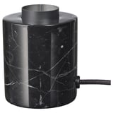 Base de lámpada de mesa de mármore negro, de forma cilíndrica, con veas brancas, cunha parte superior metálica.
