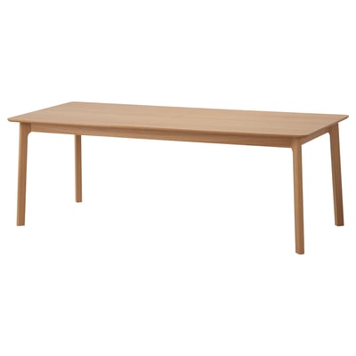 Unha mesa de comedor rectangular de madeira lixeira con liñas limpas e acabado natural. Ten catro patas espalladas e pode ser estendido para asentar máis persoas.