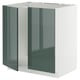 Un armario de cociña IKEA METOD con portas gris-verdes brillantes e un marco branco cun deseño moderno.