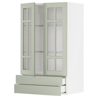 Unidade de cociña METOD en verde con portas de vidro, armarios e caixóns, fondo branco.