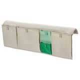 Un peto de cama MÖJLIGHET beige con bolsas internas verdes, deseñado para organizar obxectos preto dunha cama infantil.