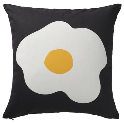 Almofada cadrada negra con deseño de ovo frito grande en branco e amarelo.