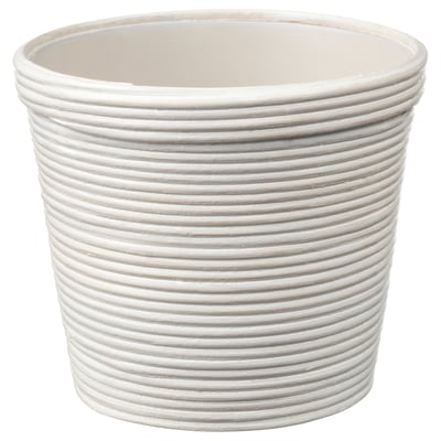 A plantadora PEKANNÖT é branca, cilíndrica con cristas verticais, feita de ratán e plástico. Está só, sinxelo pero elegante para calquera decoración.