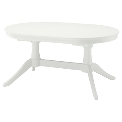 Mesa de comedor ovalada branca extensible con patas robustas, combinando funcionalidade e elegancia.