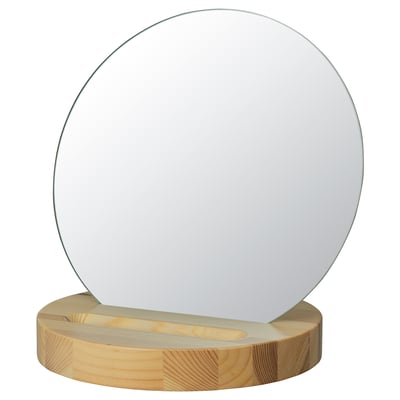 Un espello de mesa ROVERUD cunha base de madeira clara e forma redonda, cunha superficie reflectante de vidro transparente.