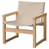 Mostra unha cadeira de brazos ikea SJÄLSÖ con tecido de cor clara e marco de madeira.