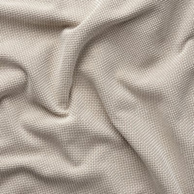 Primeiro plano de tecido beige, mostrando textura intrincada e elegantes variacións de ton.
