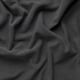 Tecido tecido gris escuro en primeiro plano, mostrando textura estreitamente tricotada e elegantes variacións de ton.