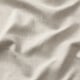 Primeiro plano de tecido beige texturizado, áreas lisas e engurradas.