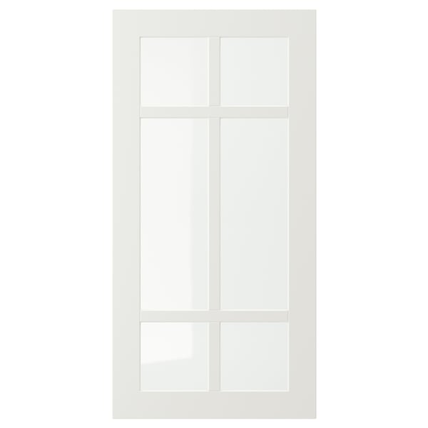 Unha porta branca de armario STENSUND cun panel de vidro dividido en catro seccións por marcos de madeira, deseñado para uso de cociña.