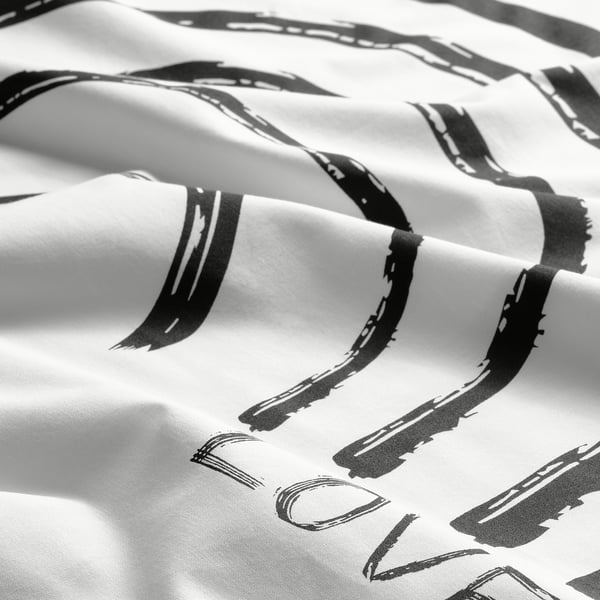 Maga de almofada abstracta con estampado en branco e negro, textura de tecido suave.