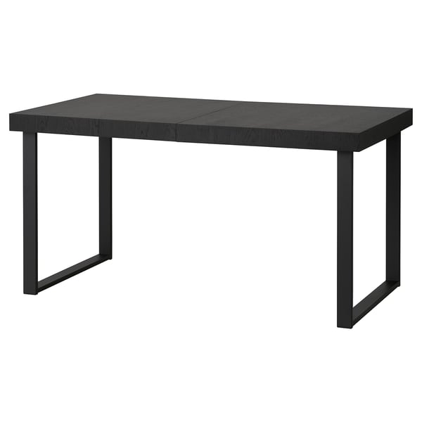 Unha mesa de comedor extensible negra TARSELE con patas metálicas, cun elegante deseño industrial.