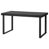 Unha mesa de comedor extensible negra TARSELE con patas metálicas, cun elegante deseño industrial.