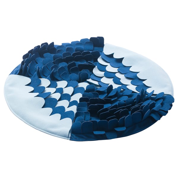 Unha alfombra azul e circular UTSÅDD para mascotas, cun deseño ondulado con poliéster reciclado.