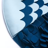 Alfombra azul e branca con poliéster reciclado, deseñada para que os cans atopan delicias, duradeiras e ecolóxicas.