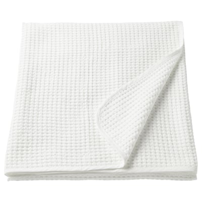 Unha cuberta branca VÅRELD, rectangular, feita de algodón 100% cun deseño de tecido texturizado.