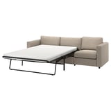 Sofá de cama beige con marco metálico negro. Sofá de cama moderna con marco negro. Sofá-cama de marco negro.