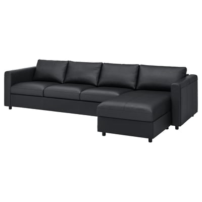 A imaxe mostra un sofá seccional VIMLE gris escuro con liñas limpas e unha chaise lounge á dereita, tapizada en coiro e tecido.