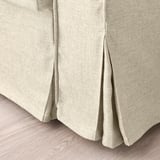 Suave tecido de sofá-cama beige en primeiro plano. Mostrando tecido suave e texturizado e costura limpa.