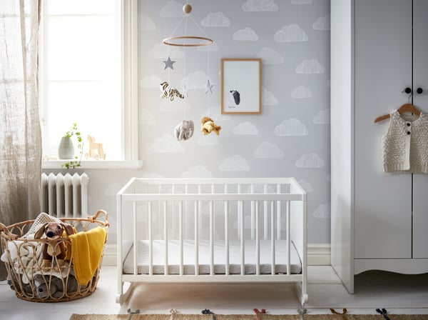A white SUNDVIK wardrobe and white SOLGUL bed in the childrens room