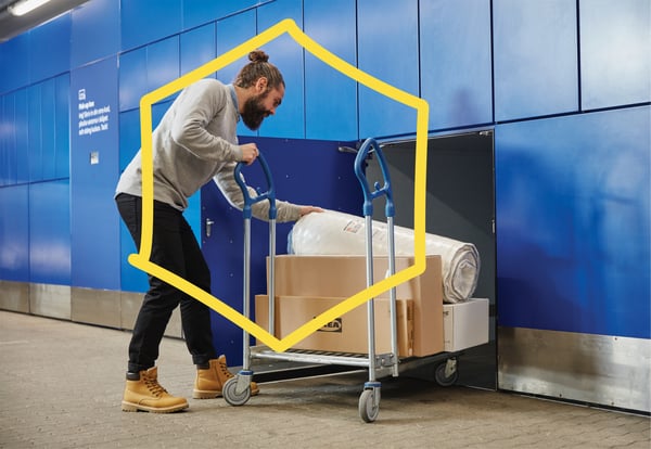 A man standing at IKEA Click & Collect with his products