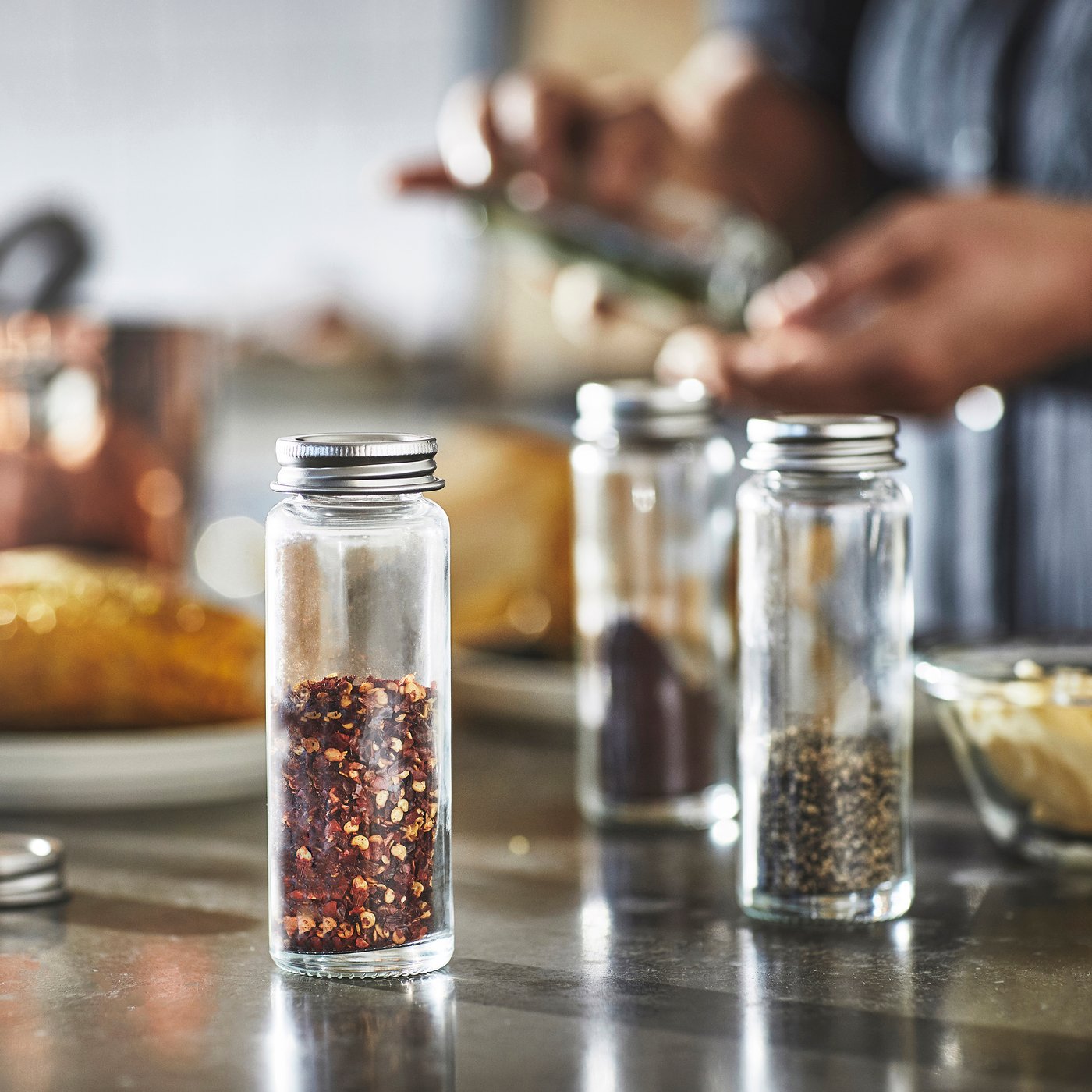 A clear glass/stainless steel CITRONHAJ spice jar in the NA
