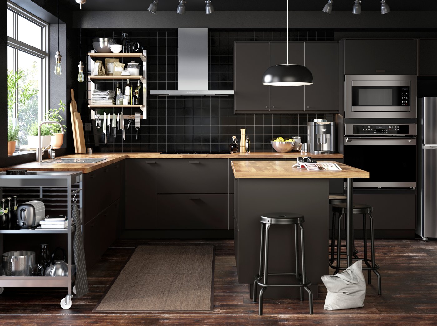 A black NYMÅNE pendant lamp in the kitchen
