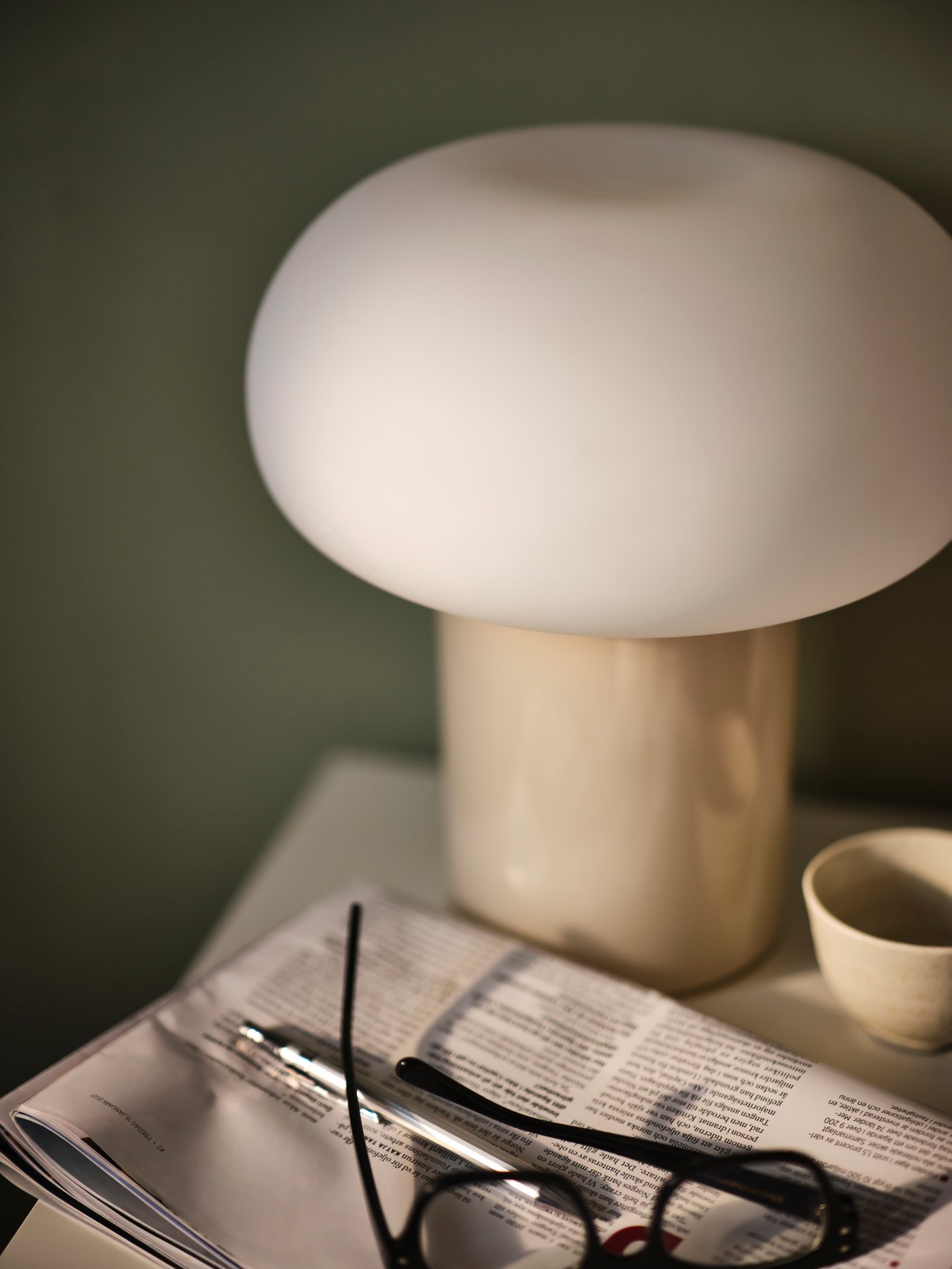 A beige/opal white glass DEJSA table lamp