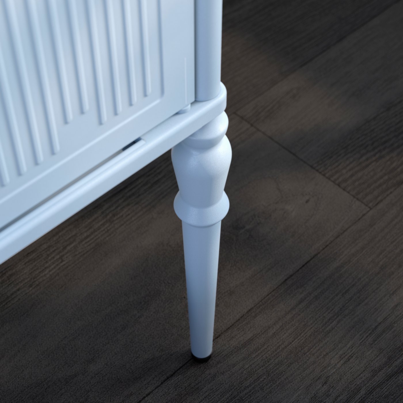 A turned leg, part of the frame and a door of a light-grey-blue SÅGMÄSTARE cabinet standing on a brown wooden floor.