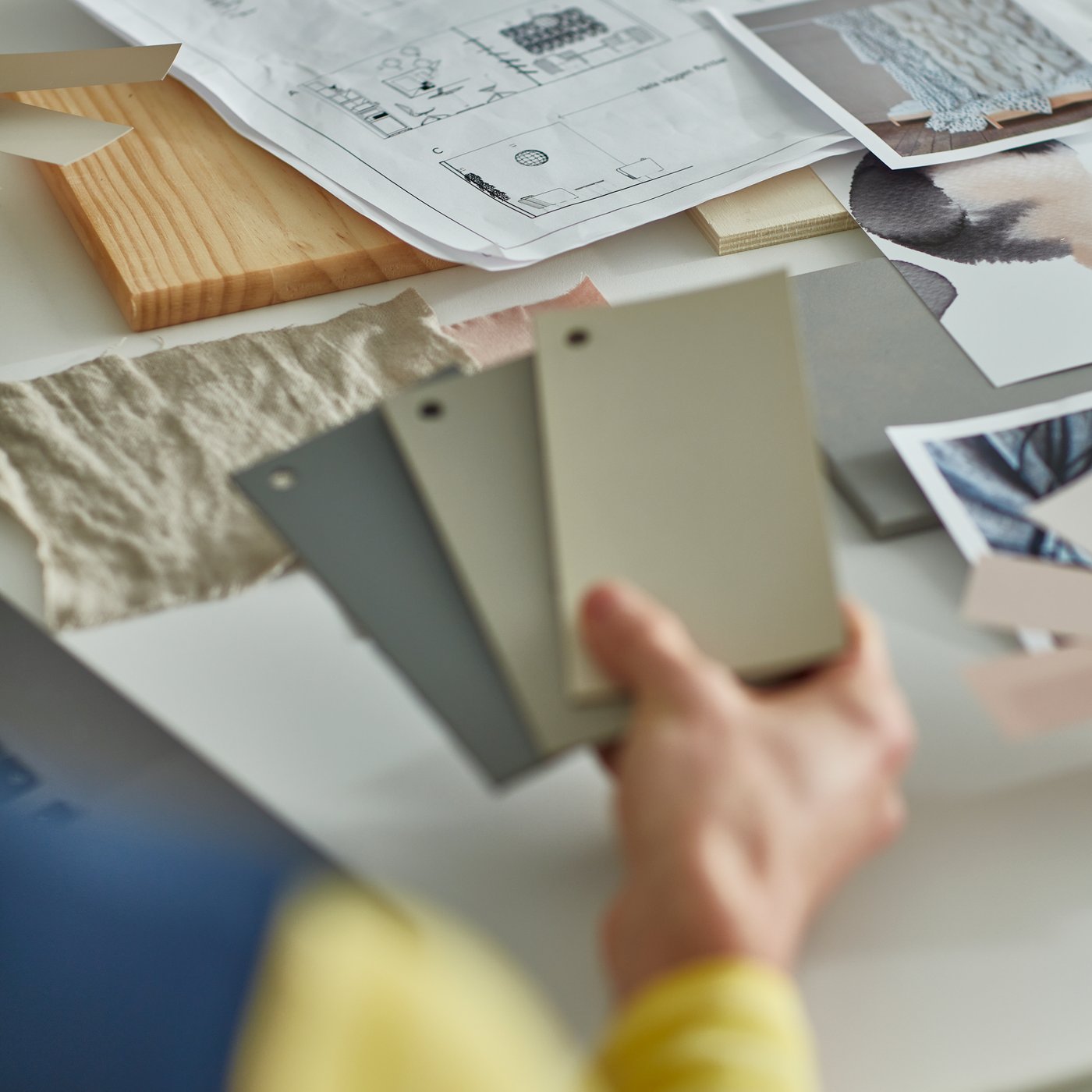 An IKEA interior design expert holding color samples in her hand.