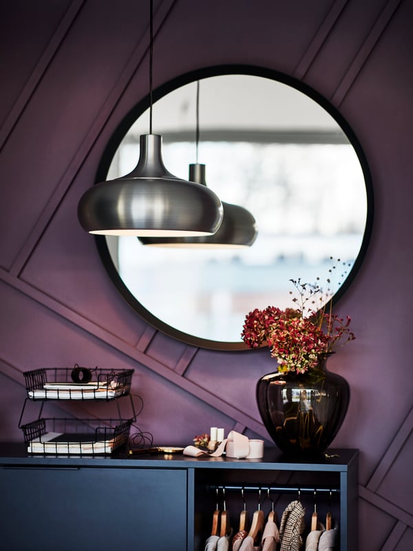 A dark grey LANGESUND mirror in the bedroom