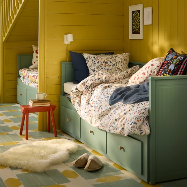 A grey-green HEMNES day-bed frame with 3 drawers