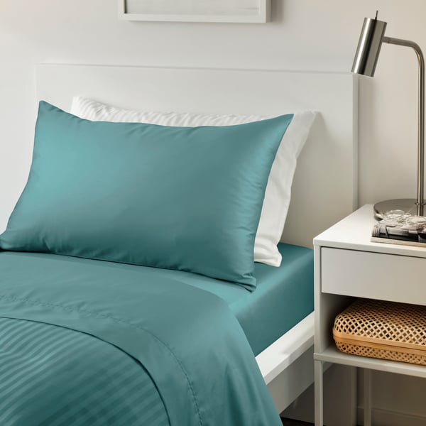 A blue-green NATTJASMIN fitted sheet