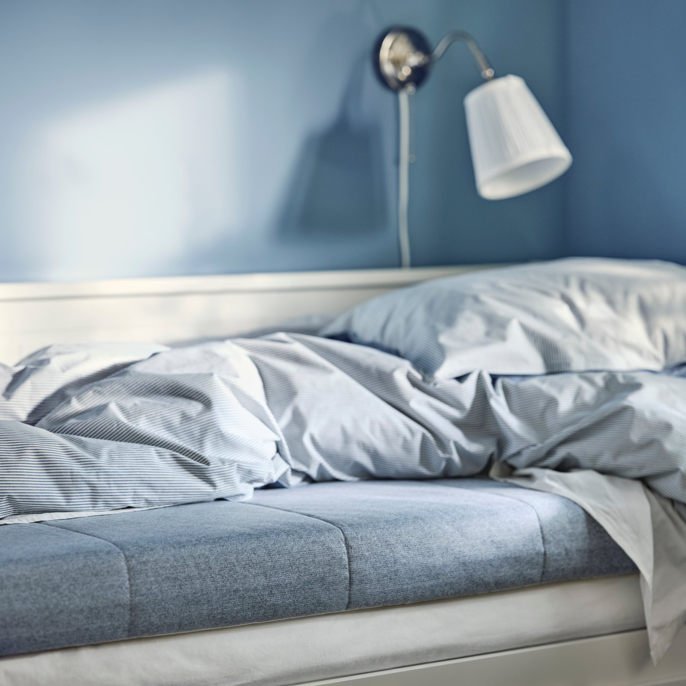A firm/light blue ÅGOTNES foam mattress