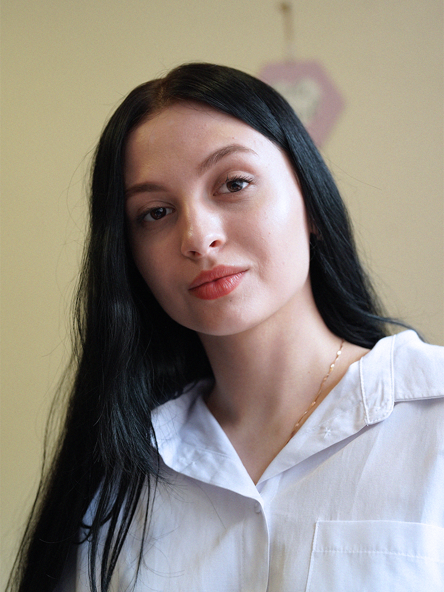 Portrait of a girl wearing a white t-shirt.