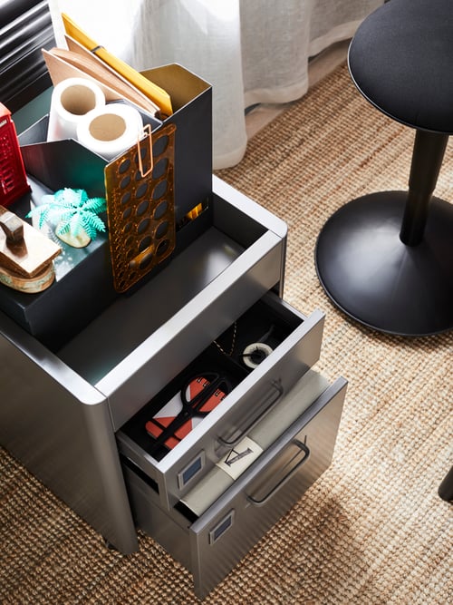 Workspace with IDÅSEN drawer unit with drawers open, TJENA magazine file, a pair of LEJONGAP curtains and a LOHALS rug.