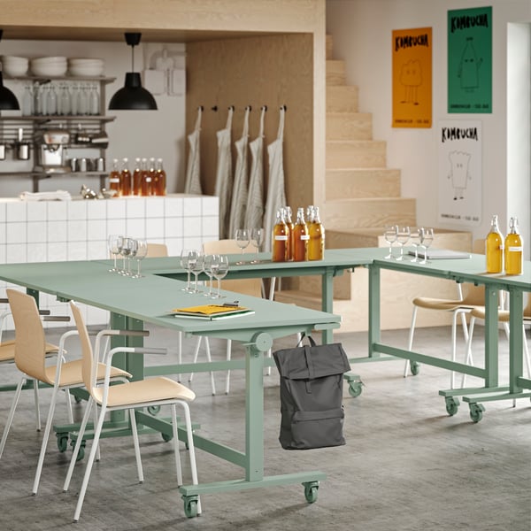 Several green MITTZON foldable tables arranged in a U-shape, paired with LÄKTARE conference chairs.