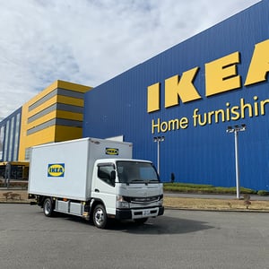 There is a truck in front of IKEA store building