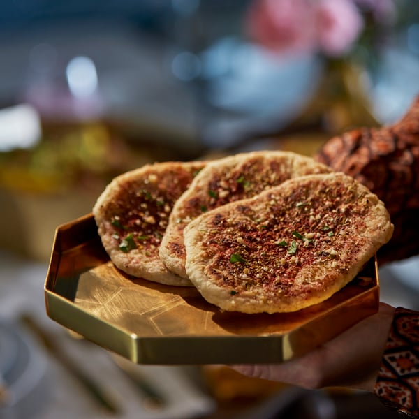 A gold-colour GOKVÄLLÅ serving tray