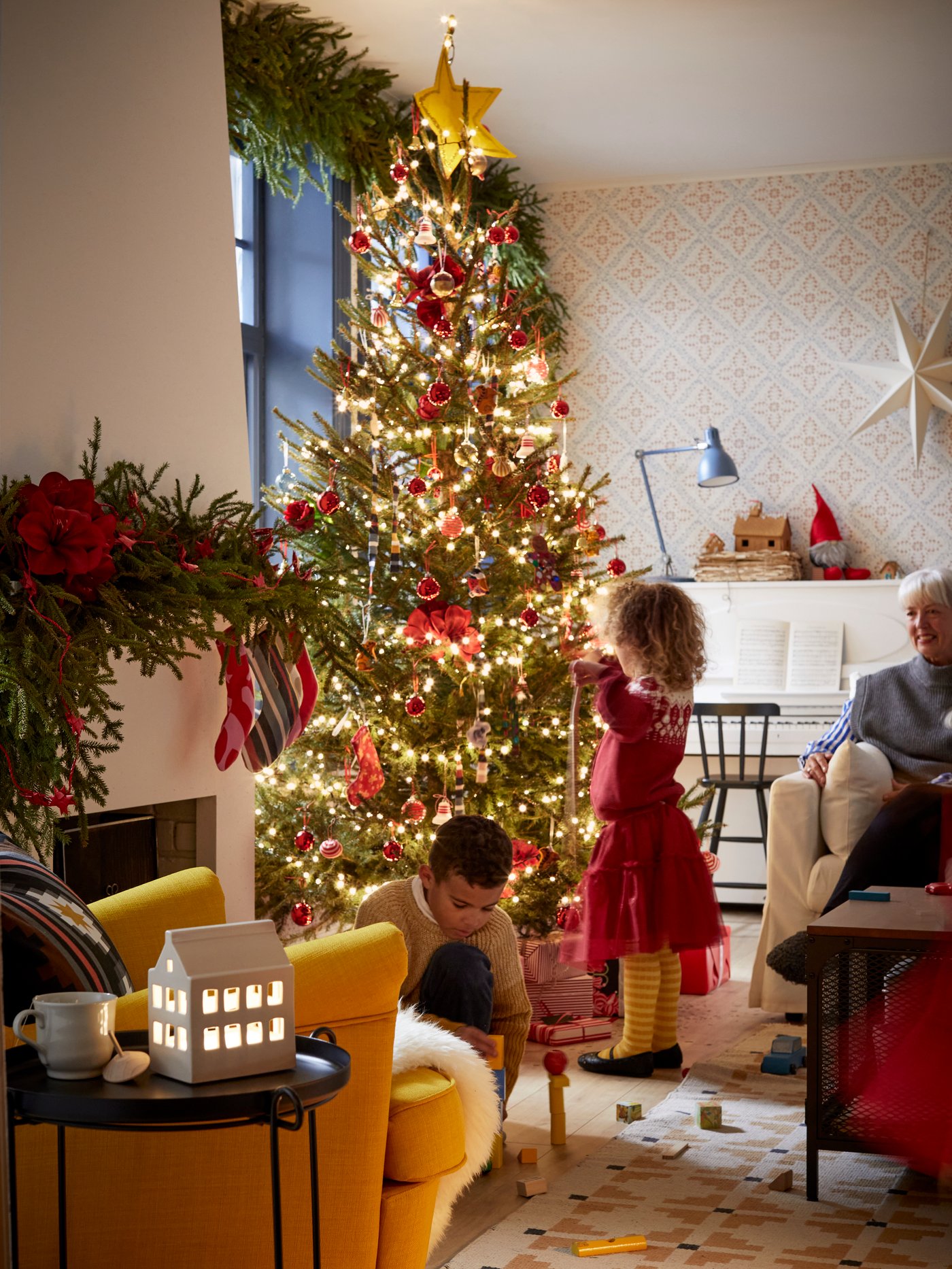 A black/orange-red FRUKTMOTT cushion cover in the living room