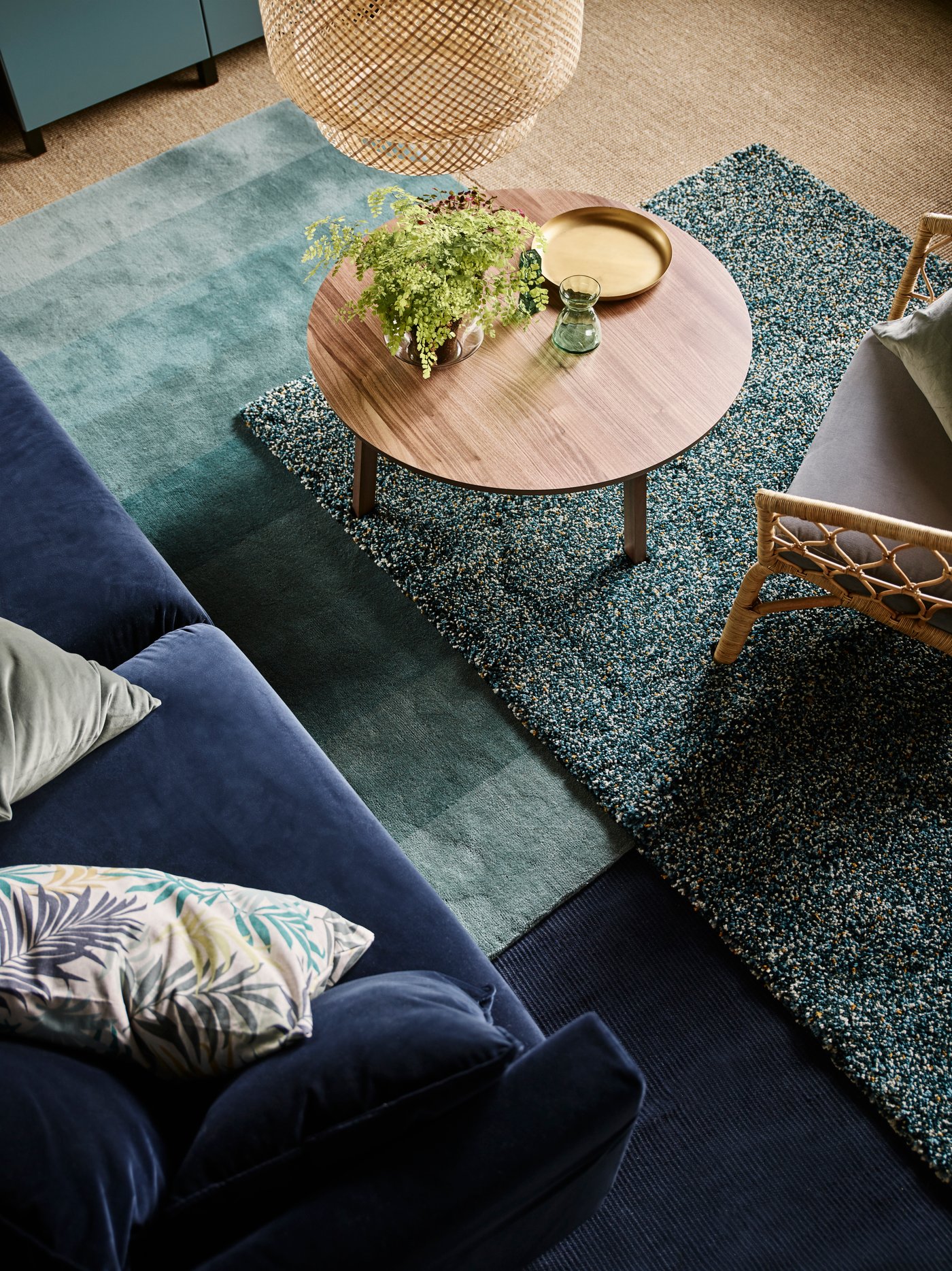 Use layers of rugs in your living room! IKEA has a lot of rugs for your living room, such as IKEA VINDUM high pile rug in blue/green and NÖDEBO handmade low pile rug in green. They are cosy to sit on and improve acoustics.
