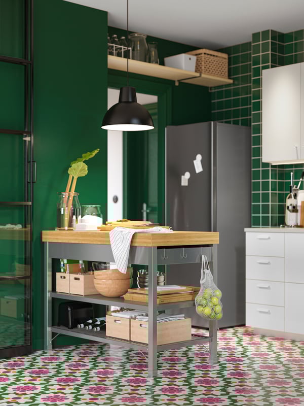 A stainless steel/bamboo RIMFORSA work bench in the kitchen