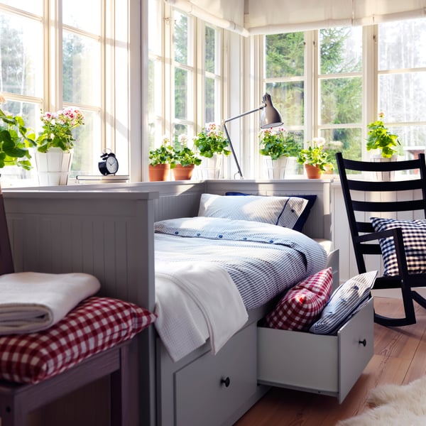 A grey HEMNES day-bed frame with 3 drawers in the bedroom