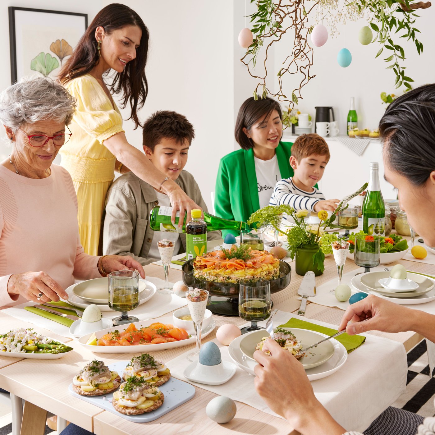 A family gathered around a table with food and surrounded by Easter decorations.