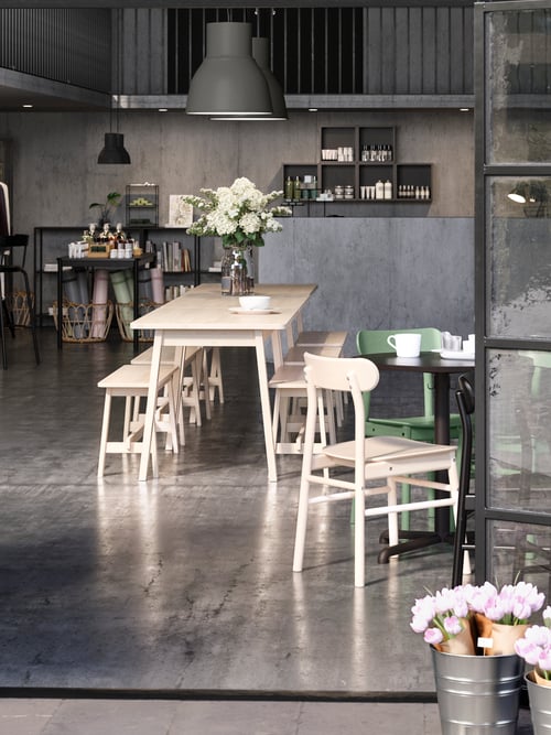 Dining area with tables, chairs, bench, plant pots, flowers, pendant lamps, mugs, serving bowls, wall shelves, vases, bar.