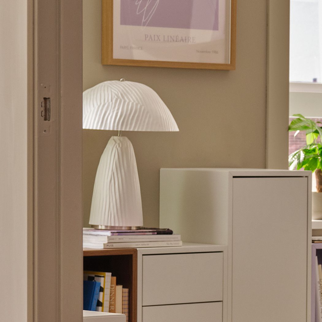 A white moulded paper pulp VINDKRAFT table lamp in the living room