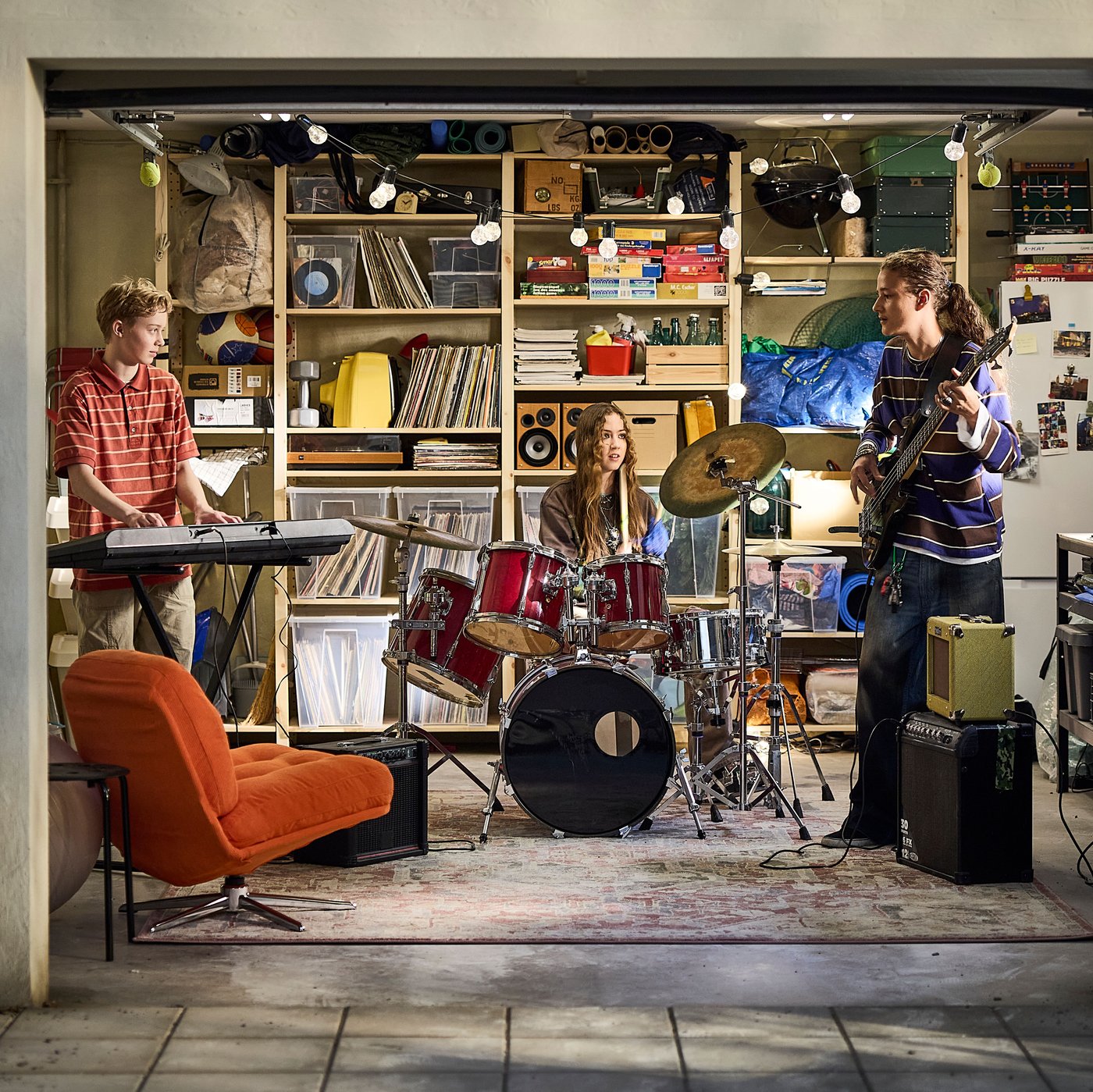 IVAR shelves and SAMLA boxes in an organised garage where a rock band is practising together.