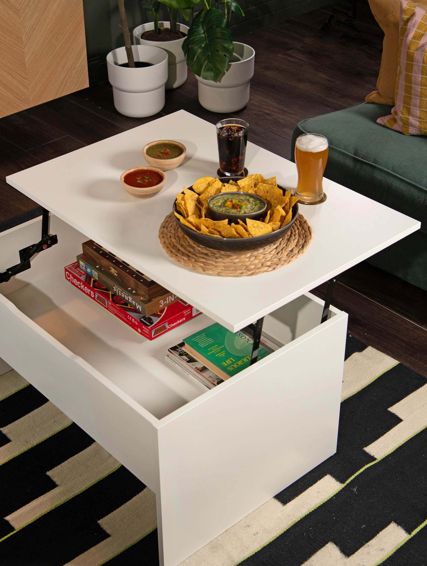 A white ÖSTAVALL adjustable coffee table